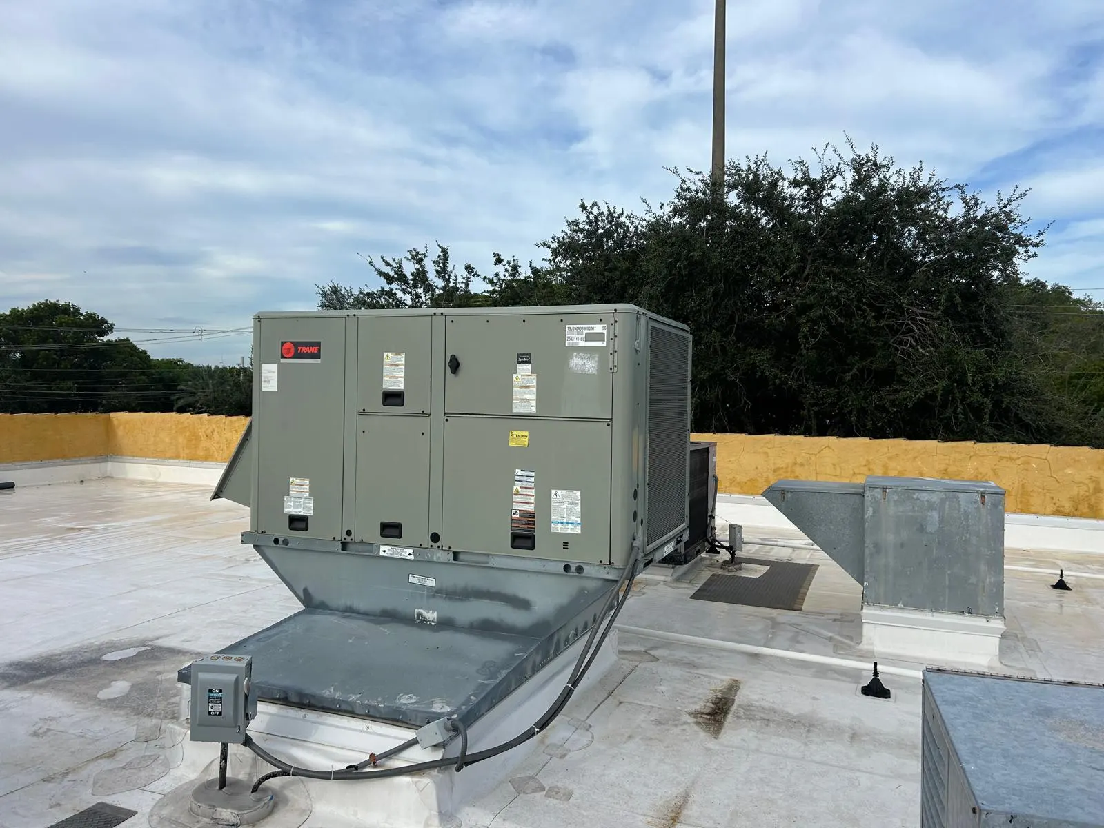 Service-side view of the completed Trane rooftop installation